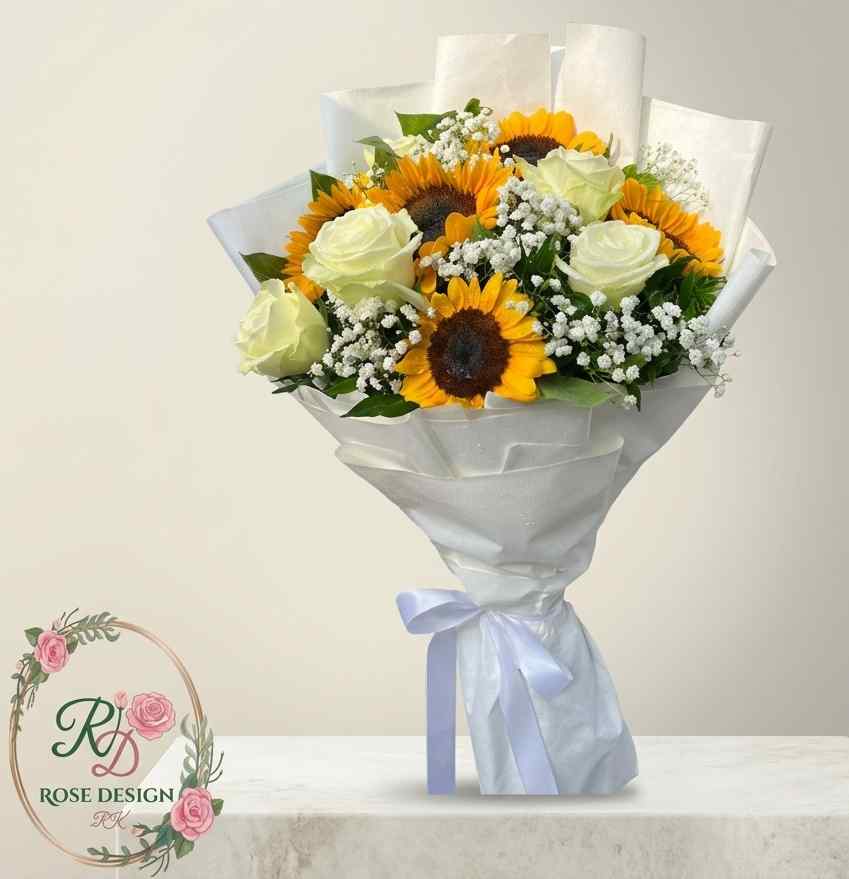 Premium mixed bouquet of sunflowers and white roses in white wrapping by Rose Design Lahore.